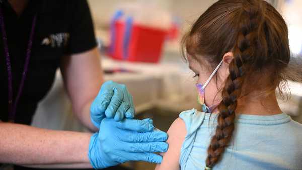 A nurse administers a pediatric dose of the COVID-19 vaccine to a girl at a L.A. Care Health Plan vaccination clinic at Los Angeles Mission College in the Sylmar neighborhood in Los Angeles, California, January 19, 2022. (Photo by ROBYN BECK/AFP via Getty Images)