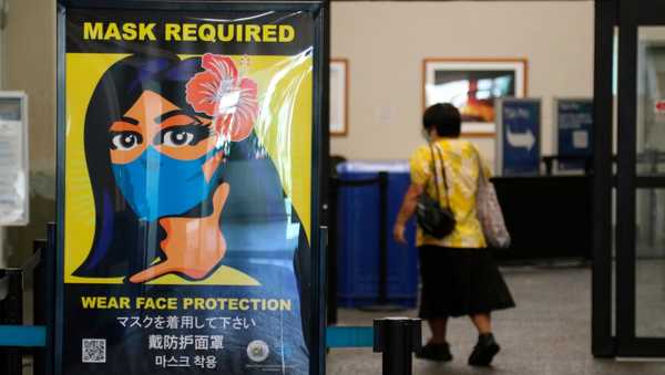 A poster at the international airport in Honolulu in 2020 showing mask requirement.