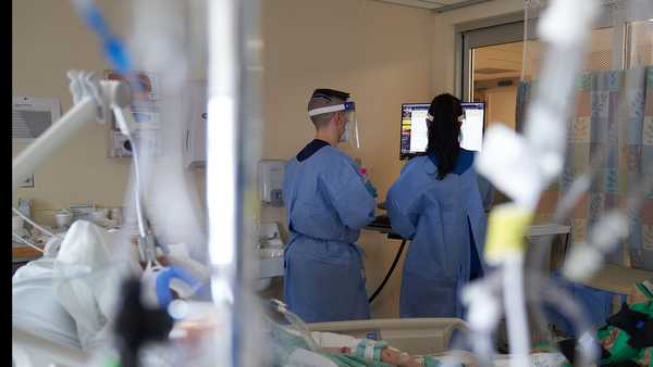 Health care workers treat a COVID-19 patient on the Intensive Care Unit (ICU) floor at Hartford Hospital in Hartford, Connecticut, U.S., on Tuesday, Feb. 1, 2022.