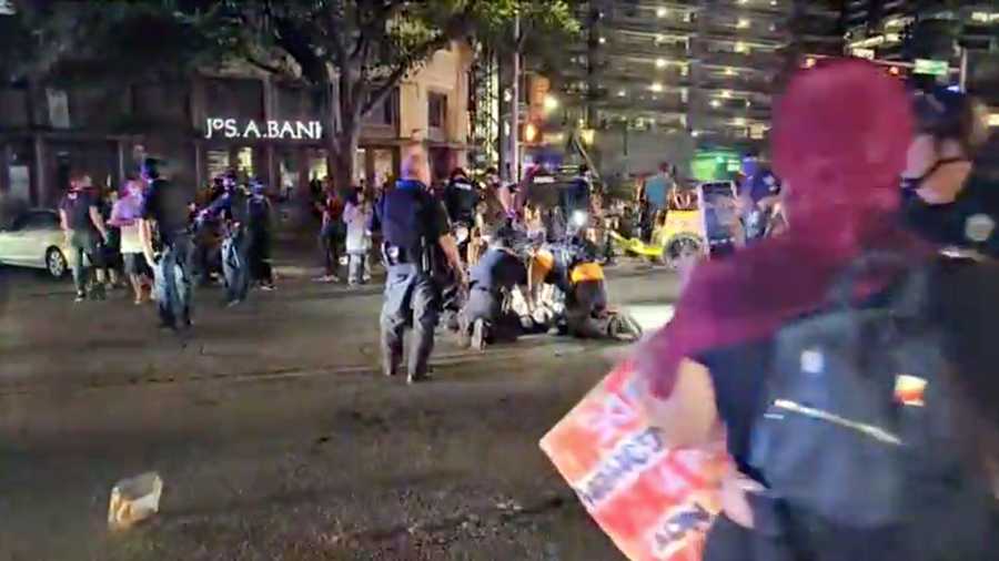 Police and protesters gather around a demonstrator who got shot after several shots were fired during a Black Lives Matter protest in downtown Austin, Texas, U.S., July 25, 2020 in this screen grab obtained from a social media video.