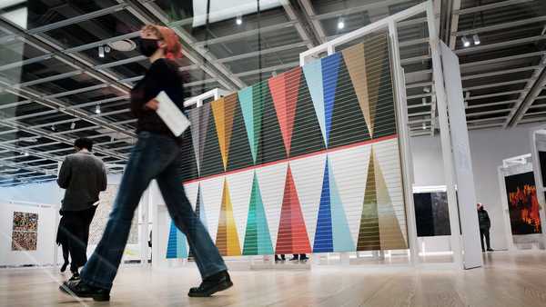 People walk through the Whitney Biennial show