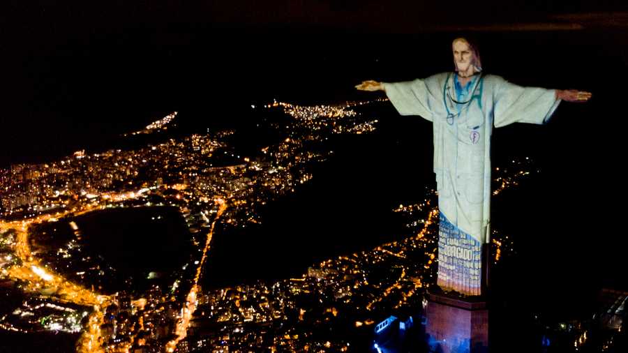 Aerial view of the illuminated statue of Christ in tribute to medical workers.