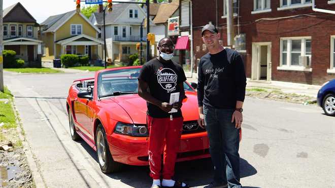 Antonio&#x20;Gwynn&#x20;Jr.,&#x20;left,&#x20;is&#x20;now&#x20;the&#x20;owner&#x20;of&#x20;a&#x20;2004&#x20;Mustang&#x20;after&#x20;Matt&#x20;Block&#x20;decided&#x20;to&#x20;give&#x20;him&#x20;the&#x20;car&#x20;as&#x20;a&#x20;reward&#x20;for&#x20;Gwynn&#x27;s&#x20;work&#x20;cleaning&#x20;up&#x20;after&#x20;protests&#x20;in&#x20;Buffalo,&#x20;New&#x20;York.