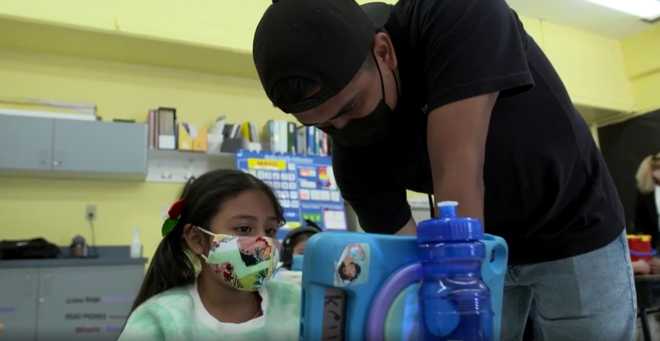 A&#x20;student&#x20;and&#x20;staff&#x20;member&#x20;work&#x20;at&#x20;a&#x20;Boys&#x20;and&#x20;Girls&#x20;Clubs&#x20;of&#x20;the&#x20;Peninsula&#x20;in&#x20;Palo&#x20;Alto,&#x20;Calif.&#x20;The&#x20;entire&#x20;staff&#x20;will&#x20;be&#x20;required&#x20;to&#x20;be&#x20;vaccinated&#x20;by&#x20;mid-June.