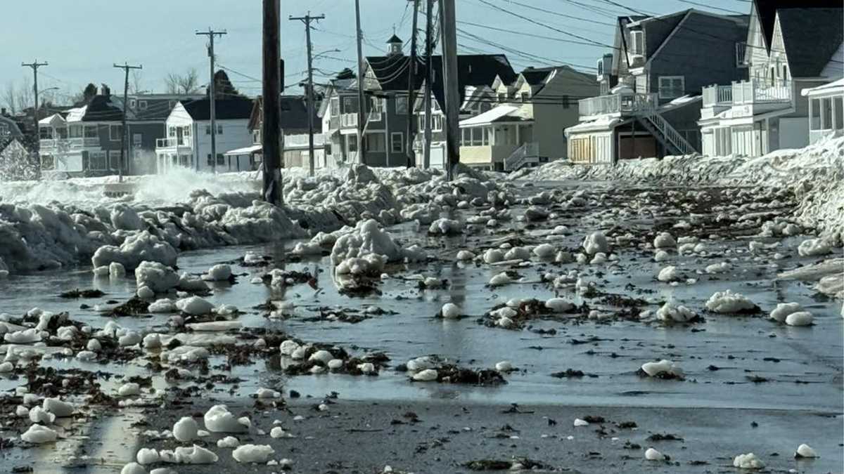 Coastal road in Wells flooded and covered with ice chunks, seaweed