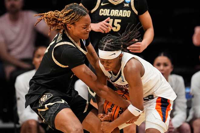 Colorado forward Jade Masogayo, left, and Illinois guard Destiny Jackson, right, battle for the ball during the first half in the first round of the NCAA college basketball tournament Saturday, March 21, 2026.