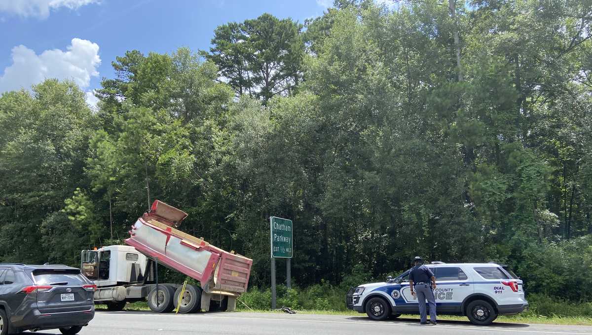 Dump truck with its bed up strikes overpass on Veterans Parkway
