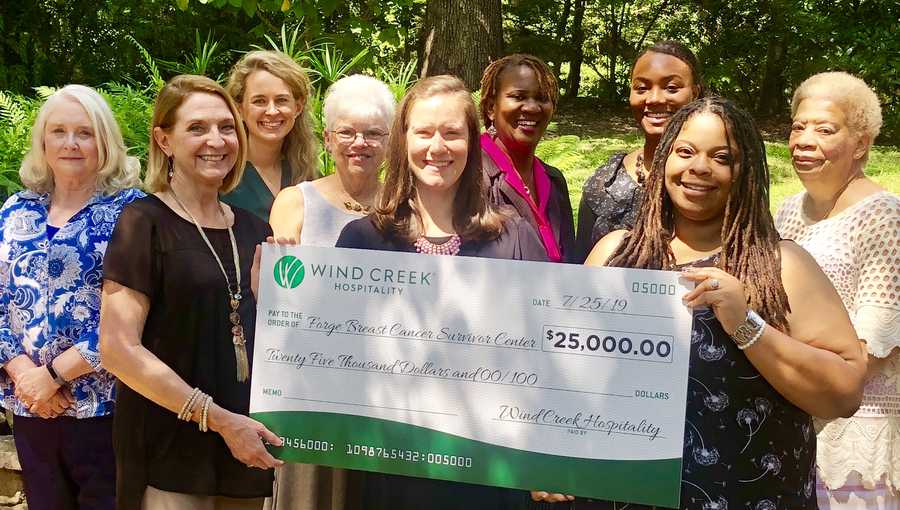 Breast Cancer Survivors and Forge volunteers and staff accept a donation from Wind Creek that will go directly to serving survivors and co-survivors in the community. From left to right: Survivor Dianne Riley, Magi Thomas of Wind Creek, Claire Gray of Forge, Survivor Betty Shivers, Co-Survivor Caroline McClain of Forge, Survivor Carla Youngblood, Jasmine Colvin of Forge, Toria Pettway of Forge, and Survivor Barbara McCray. 
