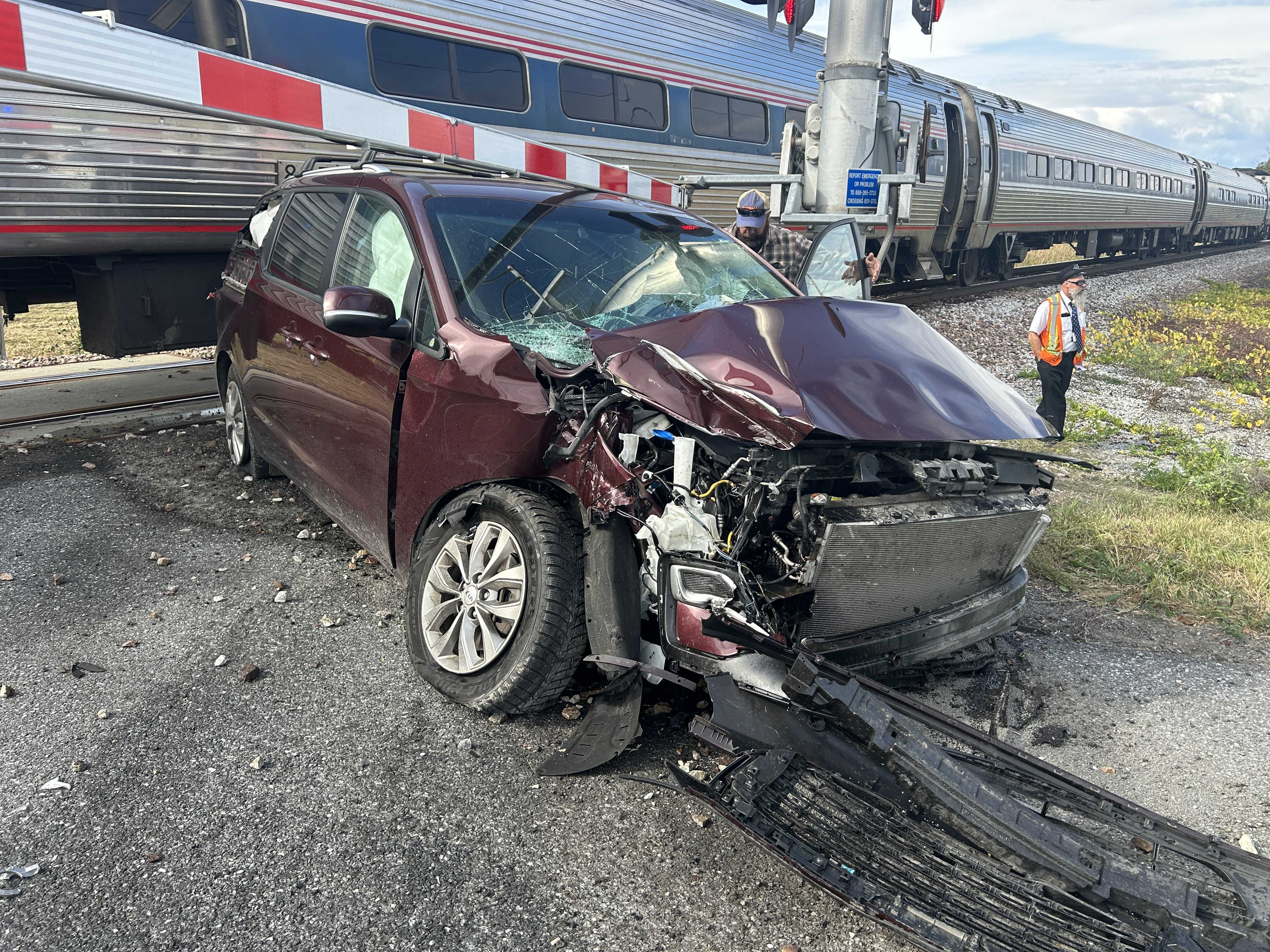 Driver fails to stop at railroad grade crossing hits vehicle