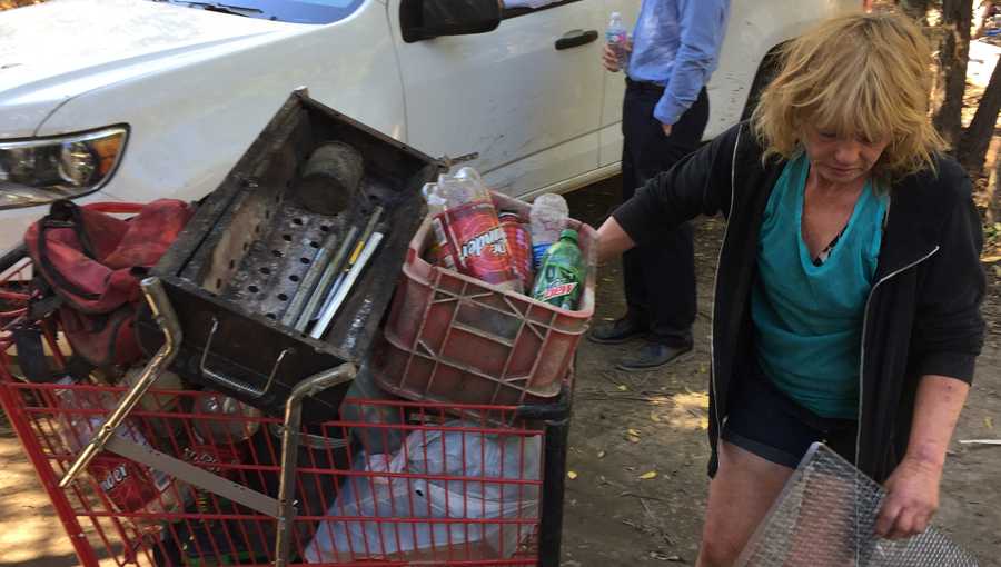 A woman picks up her belongings at the Hollywood Trailer Park in Marysville on Tuesday, Oct. 18, 2016. Yuba County code enforcement officers are clearing the area.