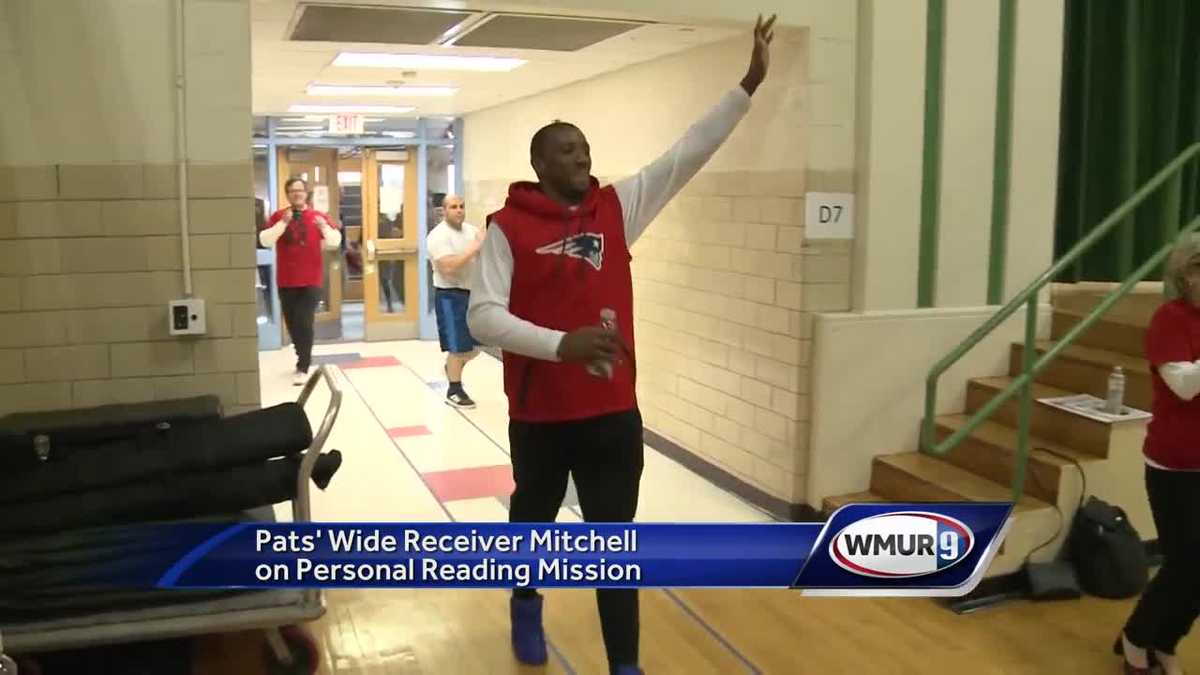 New England Patriot Malcolm Mitchell surprises students with books