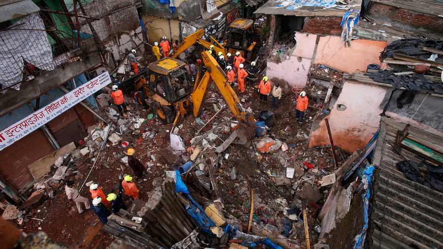 Rescuers clear the debris to find any residents possibly still trapped after a three-story dilapidated building collapsed following heavy monsoon rains n Mumbai, India, Thursday, June 10, 2021.