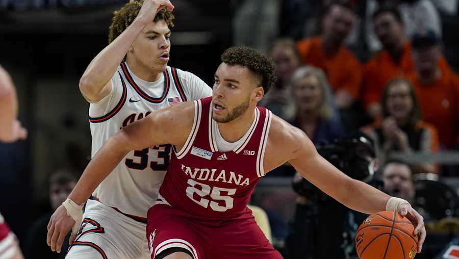 Indiana forward Race Thompson (25) drives on Illinois forward Coleman Hawkins (33) in the first half of an NCAA college basketball game at the Big Ten Conference tournament in Indianapolis, Friday, March 11, 2022. (AP Photo/Michael Conroy)