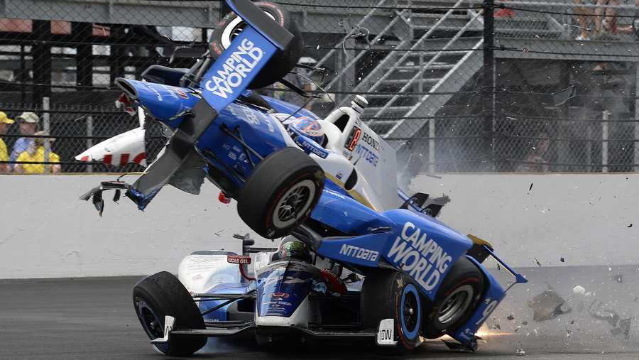 The car driven by Scott Dixon, of New Zealand, goes over the top of Jay Howard, of England, in the first turn during the running of the Indianapolis 500 auto race at Indianapolis Motor Speedway, Sunday, May 28, 2017, in Indianapolis. (AP Photo/Marty Seppala) The car driven by Scott Dixon, of New Zealand, goes over the top of Jay Howard, of England, in the first turn during the running of the Indianapolis 500 auto race at Indianapolis Motor Speedway, Sunday, May 28, 2017, in Indianapolis. (AP Photo/Marty Seppala)