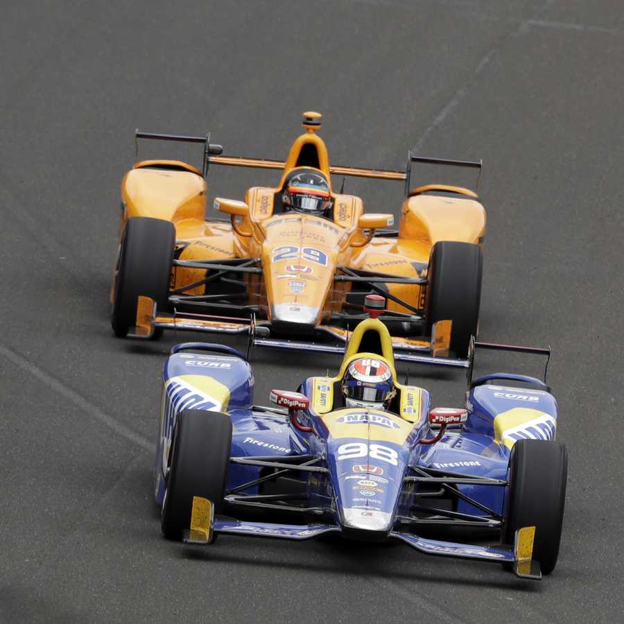 Alexander Rossi leads Fernando Alonso, of Spain, into the first turn during the running of the Indianapolis 500 auto race at Indianapolis Motor Speedway, Sunday, May 28, 2017, in Indianapolis. Alexander Rossi leads Fernando Alonso, of Spain, into the first turn during the running of the Indianapolis 500 auto race at Indianapolis Motor Speedway, Sunday, May 28, 2017, in Indianapolis.
