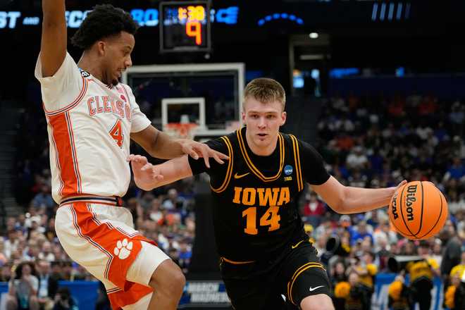 Iowa guard Bennett Stirtz (14) drives past Clemson guard Butta Johnson (4) during the first half in the first round of the NCAA college basketball tournament, Friday, March 20, 2026, in Tampa, Fla.