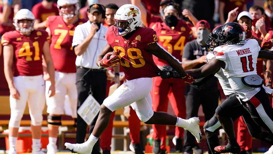 Iowa State running back Breece Hall (28) runs from Texas Tech defensive back Eric Monroe (11) during the first half of an NCAA college football game, Saturday, Oct. 10, 2020, in Ames, Iowa. (AP Photo/Charlie Neibergall)