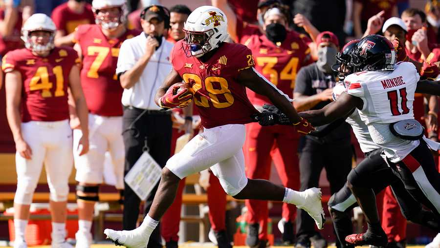 Iowa State running back Breece Hall (28) runs from Texas Tech defensive back Eric Monroe (11) during the first half of an NCAA college football game, Saturday, Oct. 10, 2020, in Ames, Iowa. (AP Photo/Charlie Neibergall)