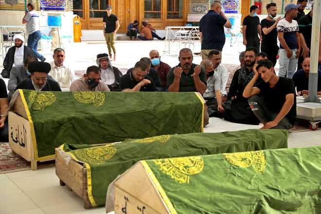 Mourners&#x20;pray&#x20;near&#x20;the&#x20;coffins&#x20;of&#x20;coronavirus&#x20;patients&#x20;who&#x20;were&#x20;killed&#x20;in&#x20;a&#x20;hospital&#x20;fire,&#x20;during&#x20;their&#x20;funeral&#x20;at&#x20;the&#x20;Imam&#x20;Ali&#x20;shrine&#x20;in&#x20;Najaf,&#x20;Iraq,&#x20;Sunday,&#x20;April&#x20;25,&#x20;2021.