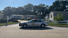 An Iowa State Patrol vehicle blocks the entrance to the Ewing Trace Mobile Home Park on the south side of Des Moines. ICE agents have confirmed that they're searching for someone in the area.