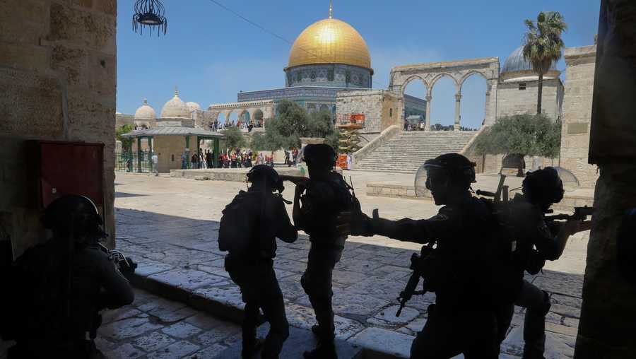 In this June 18, 2021, file photo, Israeli security forces take positions during clashes with Palestinians in front of the Dome of the Rock Mosque at the Al Aqsa Mosque compound in Jerusalem's Old City.