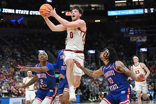 Iowa State's Nate Heise (0) heads to the basket between Tennessee State's Travis Harper II (2) and Dante Harris (10) during the first half in the first round of the NCAA college basketball tournament, Friday, March 20, 2026, in St. Louis.