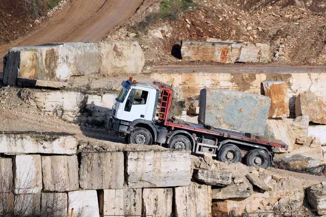A truck carries a block of travertine at the Degemar Quarry near Tivoli, Italy, 35 kilometers east of Rome, on Friday, Feb. 13, 2026, where 17th-century Baroque architect Gian Lorenzo Bernini selected travertine for the colonnade of St. Peter's Square.