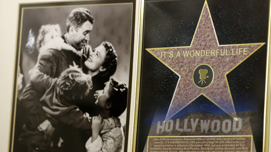 In this photo made on Friday, Dec. 20, 2013, a framed plaque with a photograph of a scene from the 1946 film "It's A Wonderful Life" starring Jimmy Stewart, left, and a Hollywood star are on display at the Jimmy Stewart Museum in Indiana, Pa.