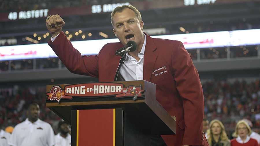 Former Tampa Bay Buccaneers safety John Lynch gestures as he is inducted in the team's Ring of Honor during halftime of an NFL football game against the Atlanta Falcons Thursday, Nov. 3, 2016, in Tampa, Fla.