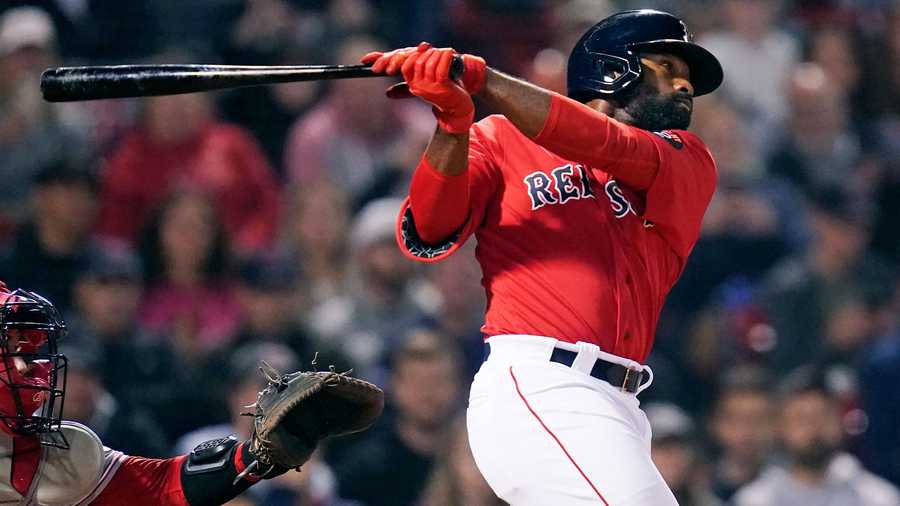 Boston Red Sox's Jackie Bradley Jr. watches his three-run triple against the Cincinnati Reds during the eighth inning of a baseball game Wednesday, June 1, 2022, at Fenway Park in Boston.