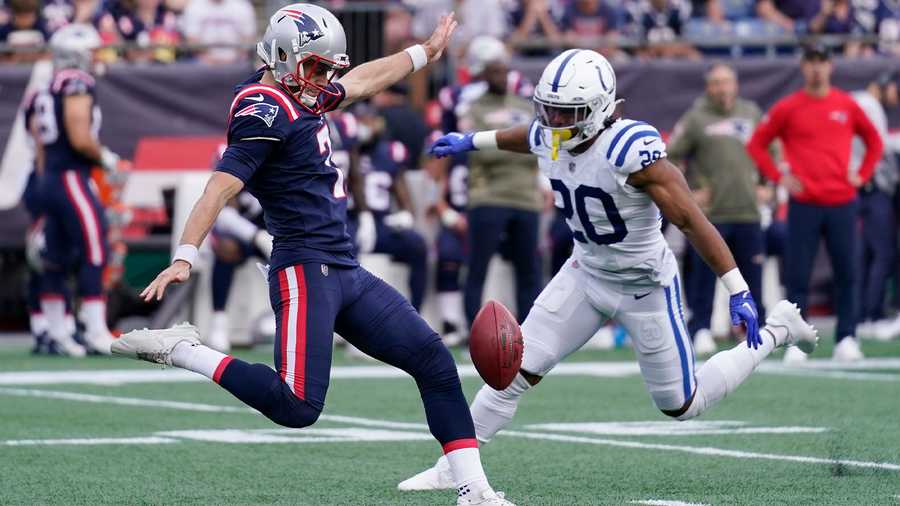 New England Patriots punter Jake Bailey (7) kicks while pressured by Indianapolis Colts safety Nick Cross (20) during an NFL football games, Sunday, Nov. 6, 2022, in Foxborough, Mass.