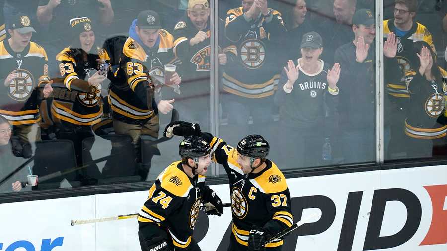 Boston Bruins' Jake DeBrusk, left, celebrates his goal with Joakim