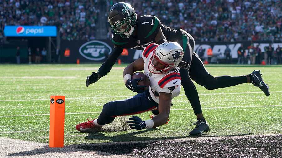 New England Patriots wide receiver Jakobi Meyers (16) crosses the goal line to score against New York Jets cornerback Sauce Gardner (1) during the third quarter of an NFL football game, Sunday, Oct. 30, 2022, in New York.