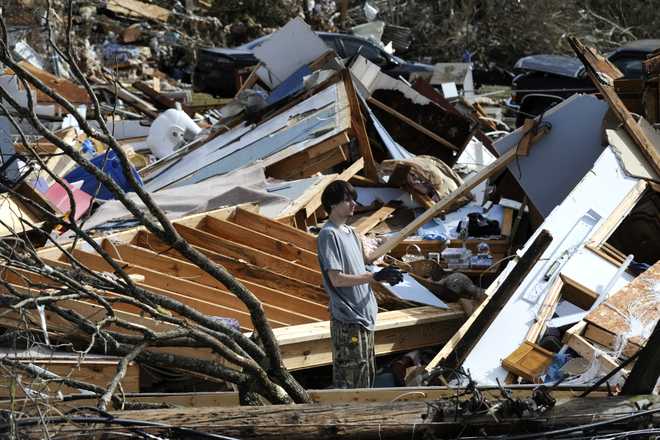 James&#x20;Scott,&#x20;19,&#x20;pauses&#x20;while&#x20;picking&#x20;through&#x20;the&#x20;remains&#x20;of&#x20;his&#x20;home,&#x20;which&#x20;was&#x20;destroyed&#x20;by&#x20;a&#x20;tornado,&#x20;on&#x20;Tuesday,&#x20;Jan.&#x20;26,&#x20;2021,&#x20;in&#x20;Fultondale,&#x20;Ala.&#x20;Scott,&#x20;who&#x20;survived&#x20;with&#x20;his&#x20;mother&#x20;and&#x20;sister,&#x20;had&#x20;never&#x20;lived&#x20;anywhere&#x20;else&#x20;and&#x20;isn&#x27;t&#x20;sure&#x20;where&#x20;he&#x20;will&#x20;wind&#x20;up&#x20;after&#x20;the&#x20;storm.