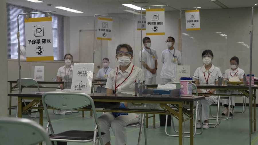 Nurses wait to process people arriving to receive the Moderna coronavirus vaccine at the newly-opened mass vaccination center in Tokyo Monay, May 24, 2021.