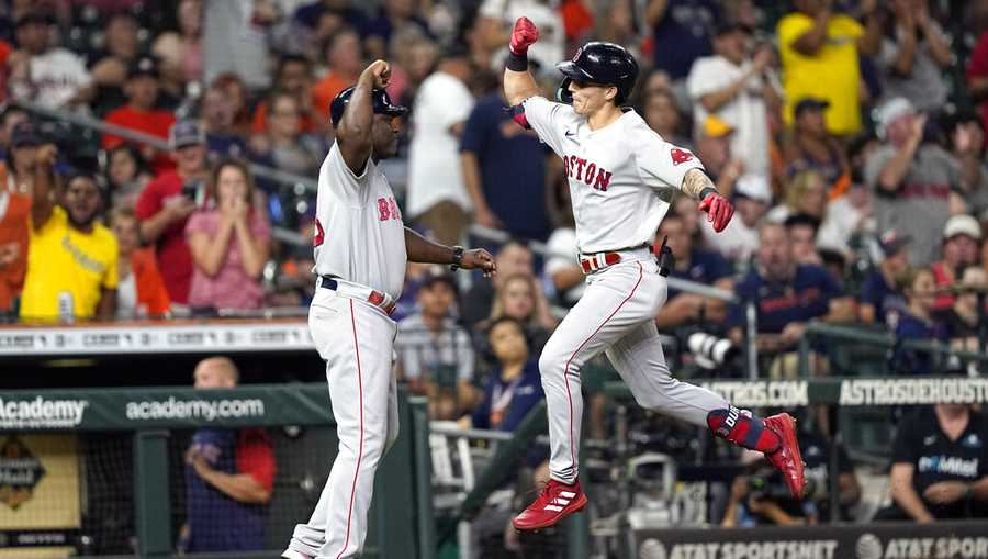 Boston Red Sox&apos;s Jarren Duran, right, celebrates with third base coach Carlos Febles after hitting a two-run home run against the Houston Astros during the fifth inning of a baseball game Monday, Aug. 1, 2022, in Houston. (AP Photo/David J. Phillip)