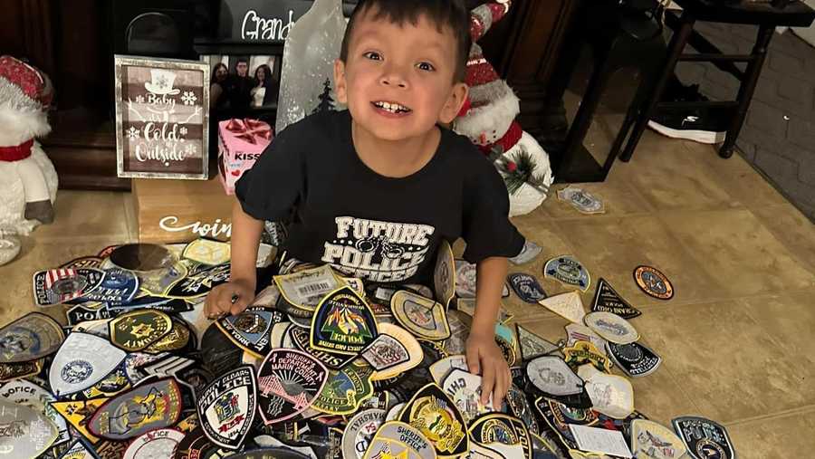 Jaxon with his pile of police patches