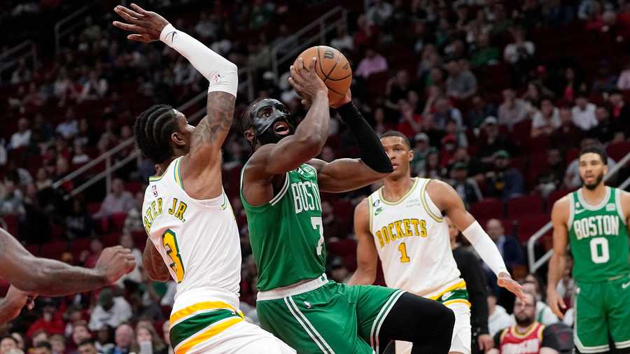 Boston Celtics' Jaylen Brown (7) goes up for a shot as Houston Rockets' Kevin Porter Jr. (3) defends during the first half of an NBA basketball game Monday, March 13, 2023, in Houston.