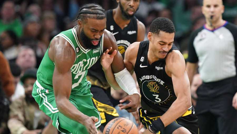 Boston Celtics guard Jaylen Brown (7) and Golden State Warriors guard Jordan Poole (3) vie for control of the ball in the first half of an NBA basketball game, Thursday, Jan. 19, 2023, in Boston. (AP Photo/Steven Senne)