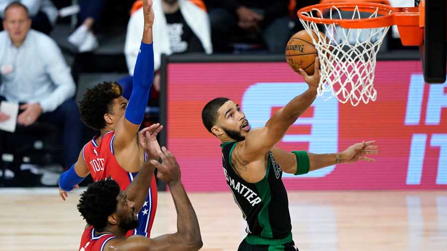 Boston Celtics' Jayson Tatum, right, goes up for a shot as Philadelphia 76ers' Joel Embiid (21) and Matisse Thybulle defend during the first half of an NBA basketball first round playoff game Monday, Aug. 17, 2020, in Lake Buena Vista, Fla. (AP Photo/Ashley Landis, Pool)