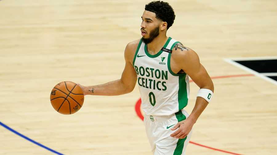Boston Celtics forward Jayson Tatum (0) dribbles against the Los Angeles Clippers during the first half of an NBA basketball game Friday, Feb. 5, 2021, in Los Angeles. (AP Photo)