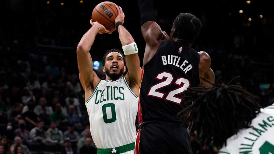 Boston Celtics forward Jayson Tatum (0) shoots over Miami Heat forward Jimmy Butler (22) during the second half of Game 4 of the NBA basketball playoffs Eastern Conference finals, Monday, May 23, 2022, in Boston.
