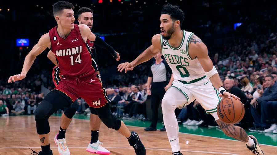 Boston Celtics forward Jayson Tatum (0) drives to the basket against Miami Heat guard Tyler Herro (14) during the first half of an NBA basketball game Wednesday, Nov. 30, 2022, in Boston.