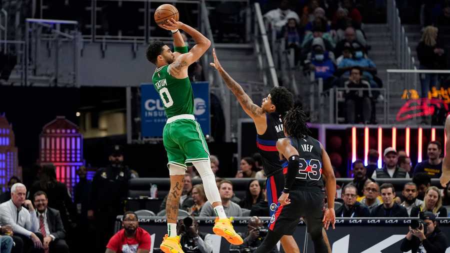 Boston Celtics forward Jayson Tatum (0) shoots over the defense of Detroit Pistons guard Killian Hayes during the second half of an NBA basketball game, Saturday, Nov. 12, 2022, in Detroit.