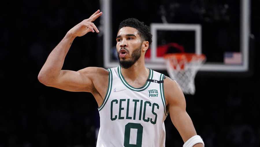 Boston Celtics forward Jayson Tatum (0) blows a kiss to the crowd after scoring three points during the second half of Game 4 of an NBA basketball first-round playoff series against the Brooklyn Nets, Monday, April 25, 2022, in New York. (AP Photo/John Minchillo)