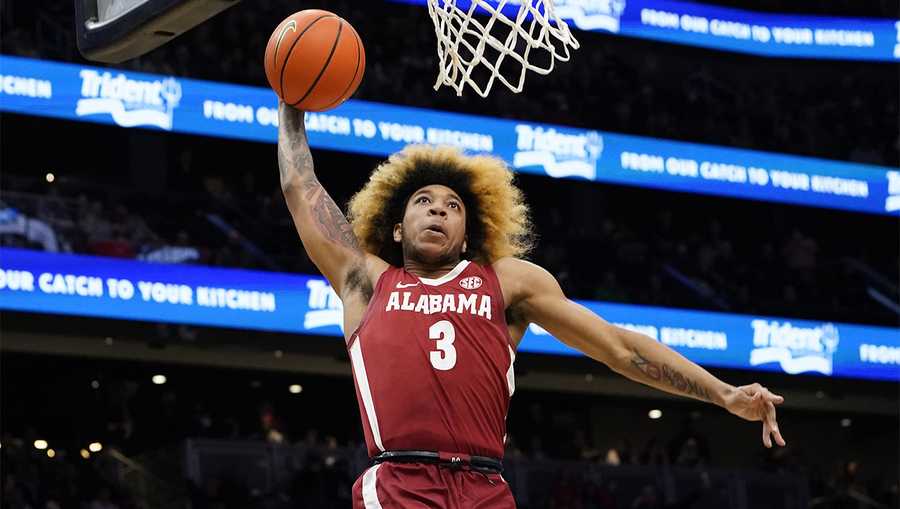 Alabama's JD Davison heads toward the basket for a dunk against Gonzaga during the second half of an NCAA college basketball game Saturday, Dec. 4, 2021, in Seattle. Alabama won 91-82.
