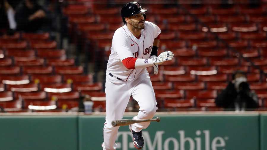 Boston Red Sox's J.D. Martinez watches his two-run double during the 12th inning of a baseball game against the Tampa Bay Rays, Tuesday, April 6, 2021, in Boston. (AP Photo)