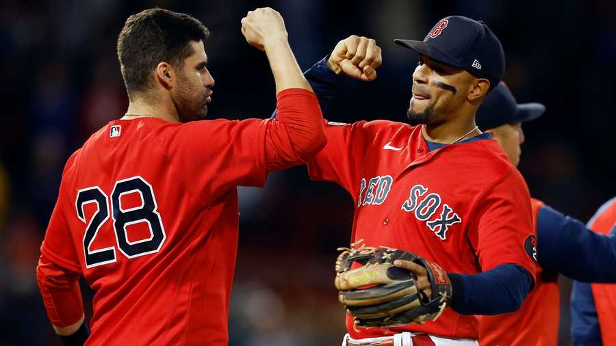 Boston Red Sox's J.D. Martinez (28) and Xander Bogaerts celebrate after defeating the Kansas City Royals during the ninth inning of a baseball game, Friday, Sept. 16, 2022, in Boston.