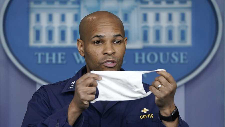 U.S. Surgeon General Jerome Adams holds up his face mask during the daily briefing of the coronavirus task force at the White House on April 22, 2020 in Washington, DC.