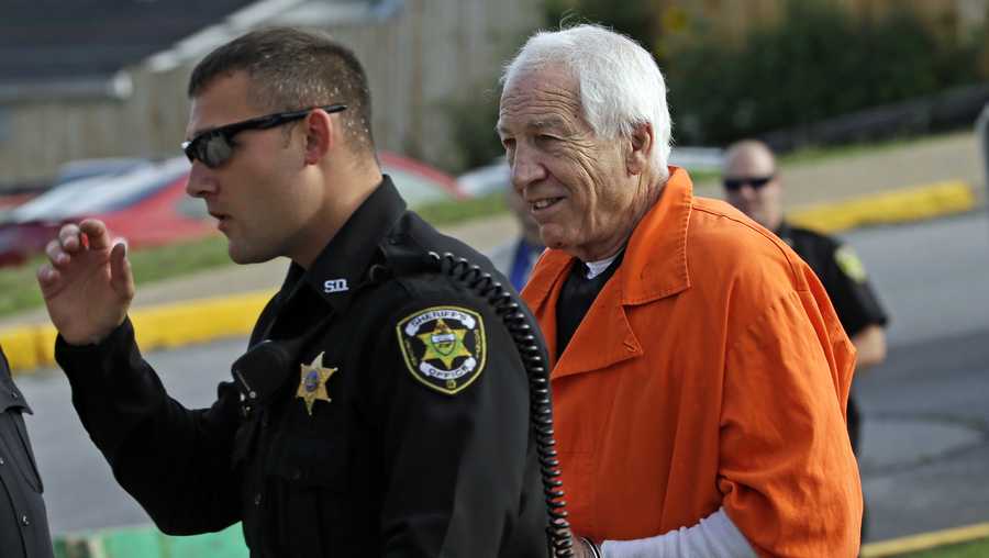 Former Penn State University assistant football coach Jerry Sandusky, right, arrives at the Centre County Courthouse.